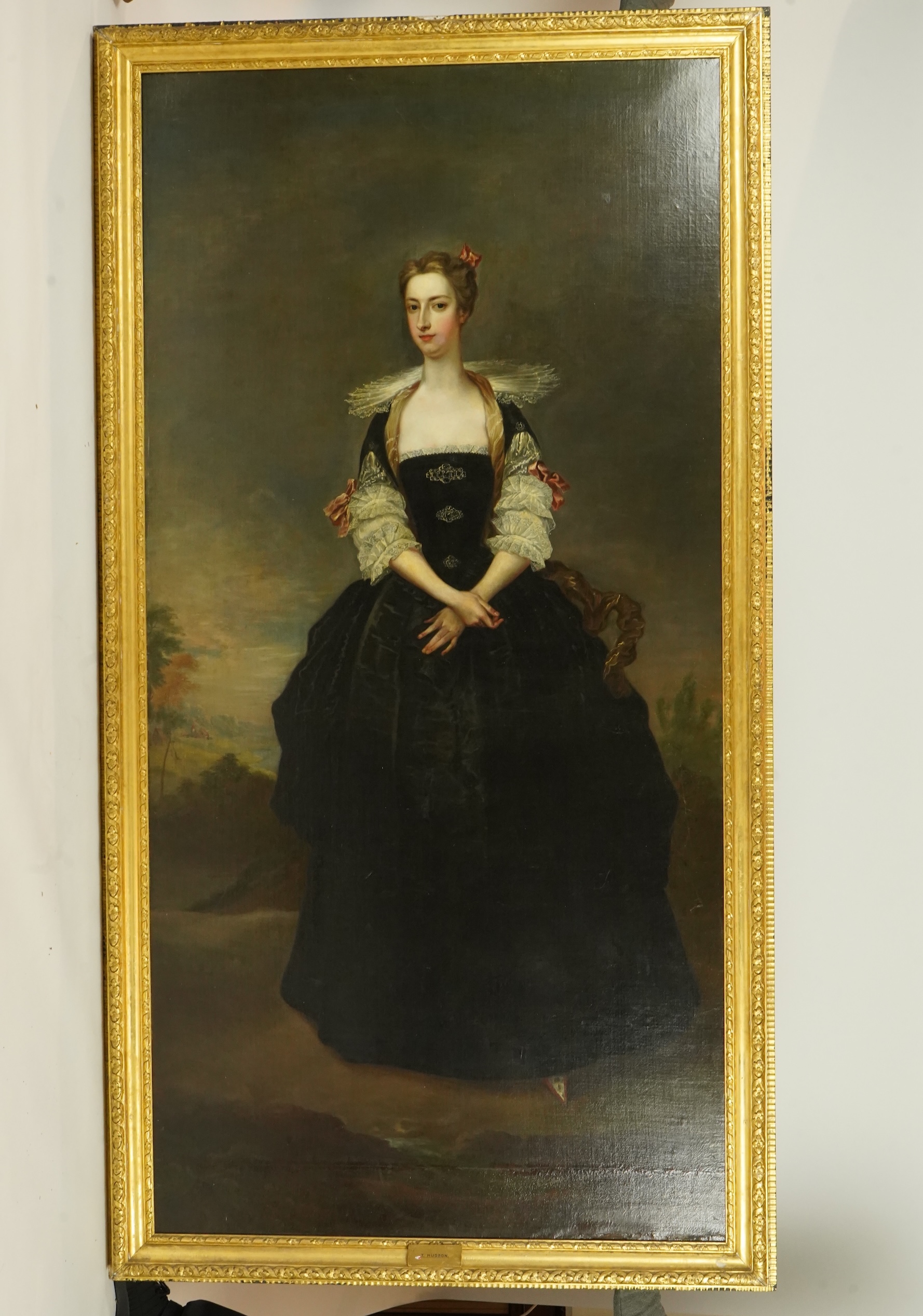 Charles Jervas (English, c.1675-1739), Portrait of a lady said to be a member of the Dundas Family, full length in black Van Dyck dress, in a landscape, oil on canvas, 255 x 127cm